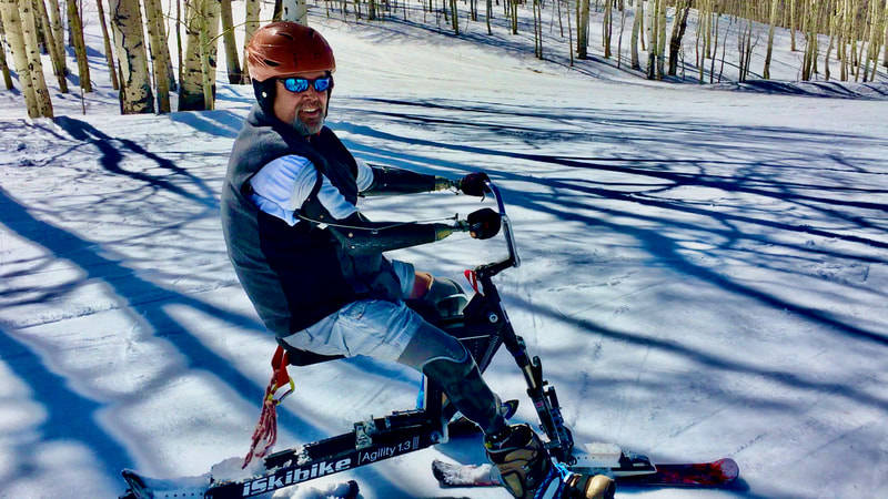 An adaptive skier enjoys renewed skiing agility and freedom on his iSkibike at the National Disabled Veterans Winter Sports Clinic, Snowmass, Colorado.