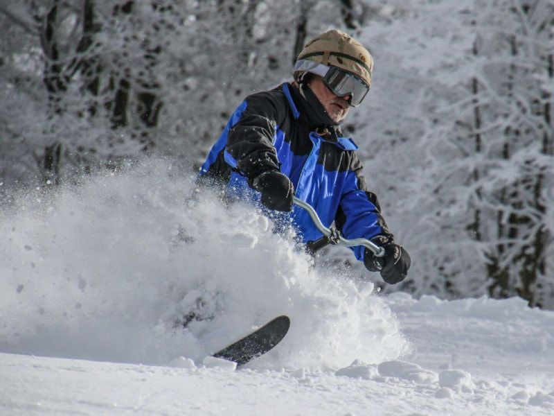 Picture of an iSkibike rider skiing powder snow..
