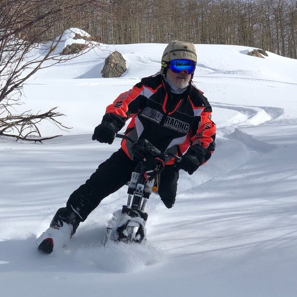 An adaptive ski biker cruises through untracked powder on his iSkibike with the Steamboat Powder Cats, Steamboat Springs, Colorado.