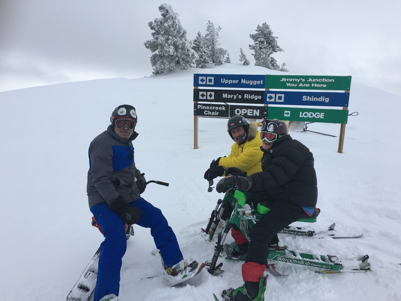 Three ski bikers, deciding which ski run will have the best powder, pose with their iSkibikes, Bogus Basin ski resort, Boise, Idaho.