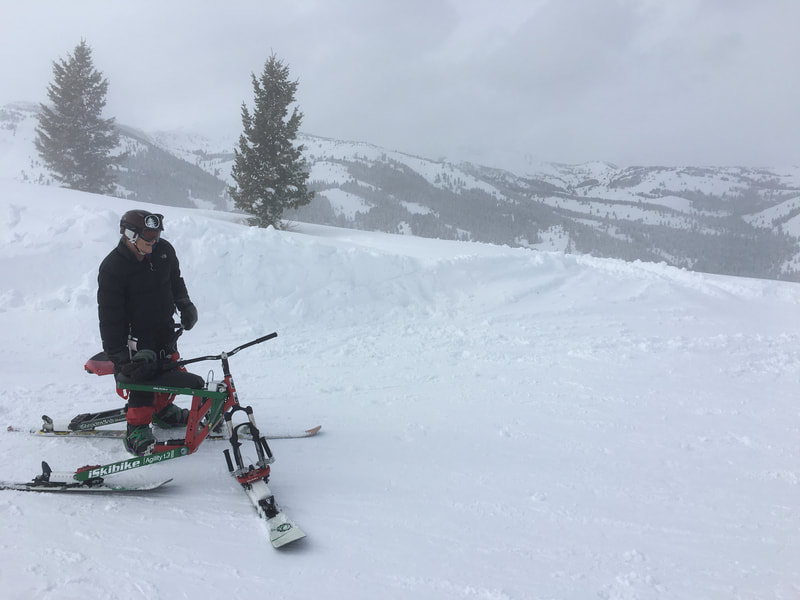 An adaptive ski biker poses at the top of Soldier Mountain,  a little known skiing gem, near Fairfield, Idaho,  ready to show off her iSkibike in the deep powder.