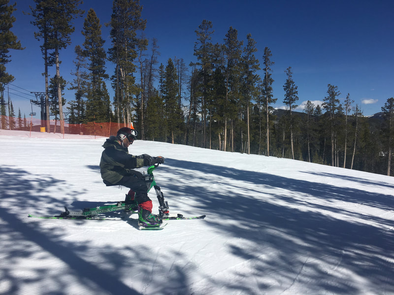 An adaptive ski biker enjoys spring skiing on her iSkibike at the Discovery Ski Resort near Philipsburg, Montana.